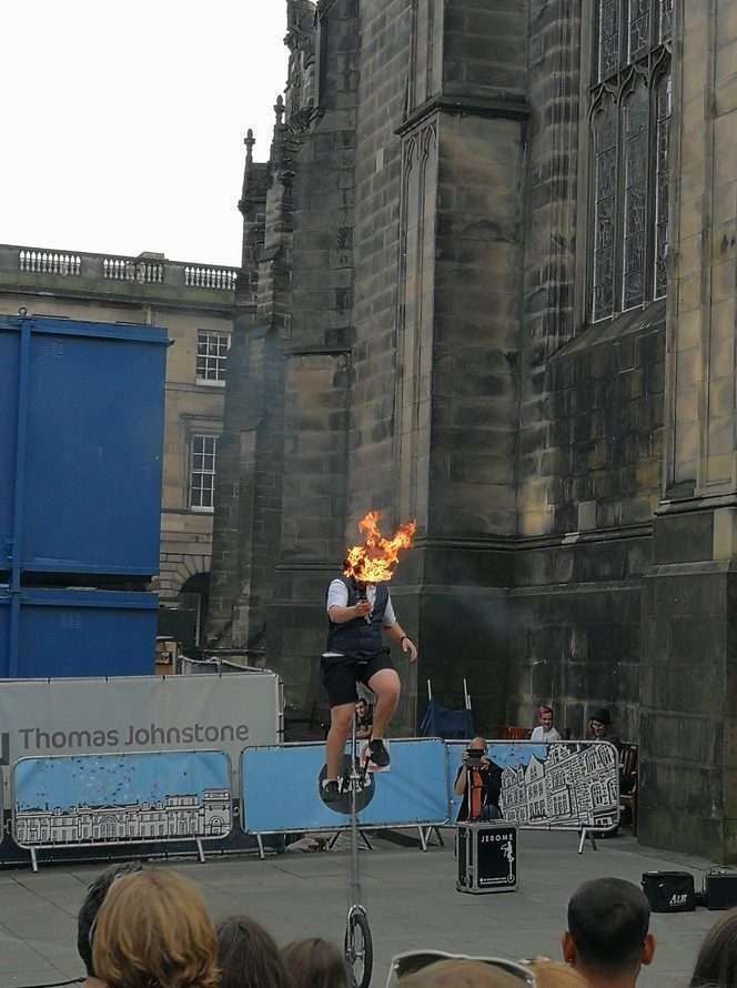 Persona sopra monociclo con fiaccola