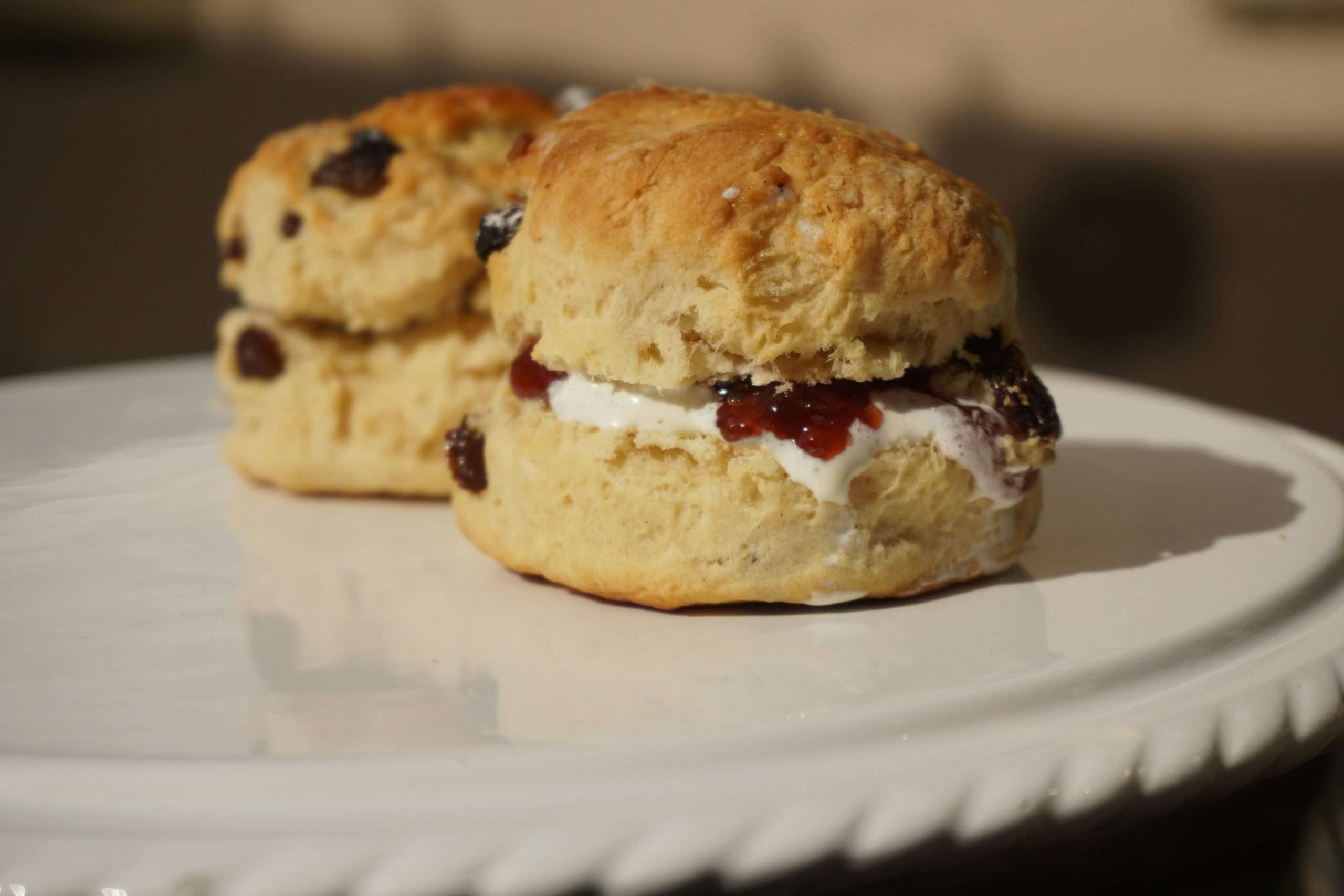 piatto con due focaccine dolci con all'interno marmellata e crema, scones per mangiare a colazione a edimburgo